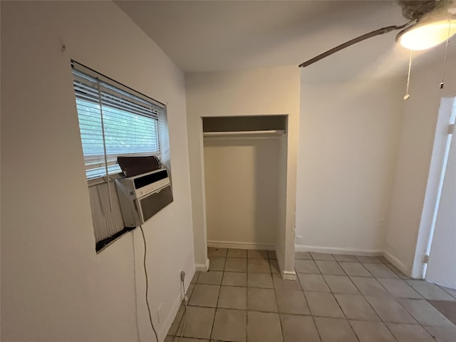 unfurnished bedroom with a closet, ceiling fan, and light tile patterned flooring