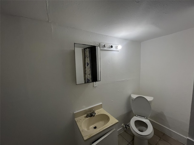 bathroom with vanity, toilet, and tile patterned floors