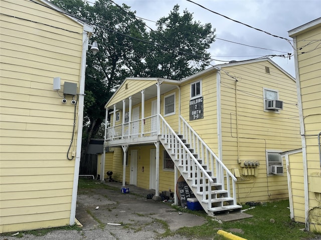 rear view of house featuring a porch and cooling unit