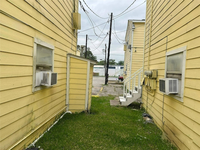 view of home's exterior with a yard and cooling unit