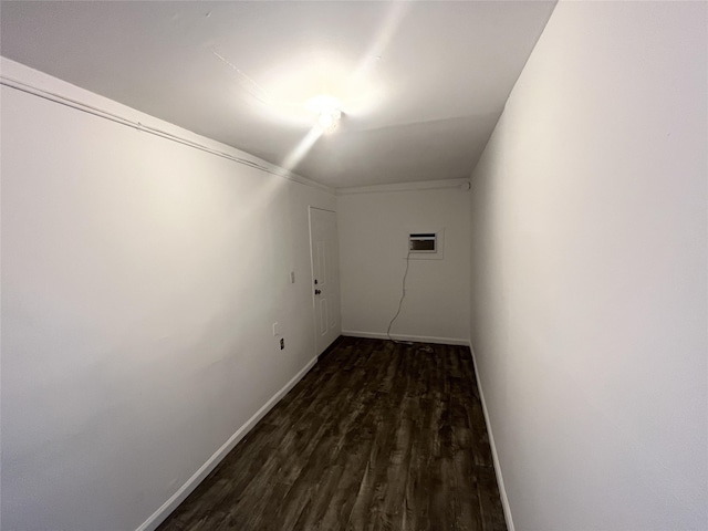 interior space with a wall mounted AC and dark hardwood / wood-style flooring