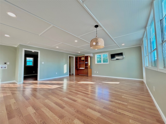 unfurnished living room with light hardwood / wood-style flooring and crown molding