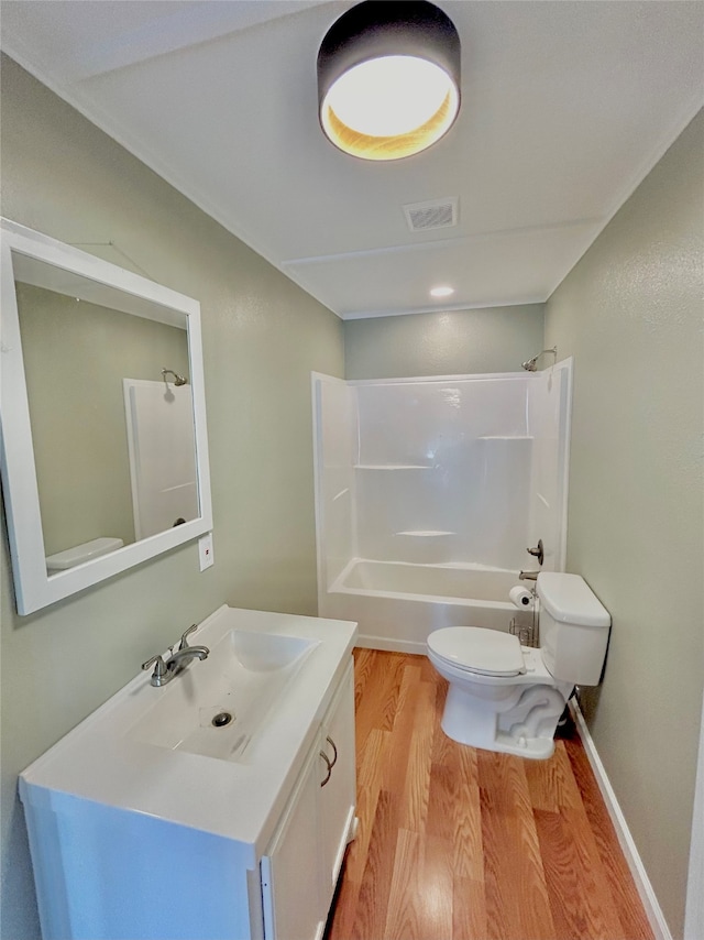 full bathroom with vanity, hardwood / wood-style floors, toilet, and shower / bathtub combination