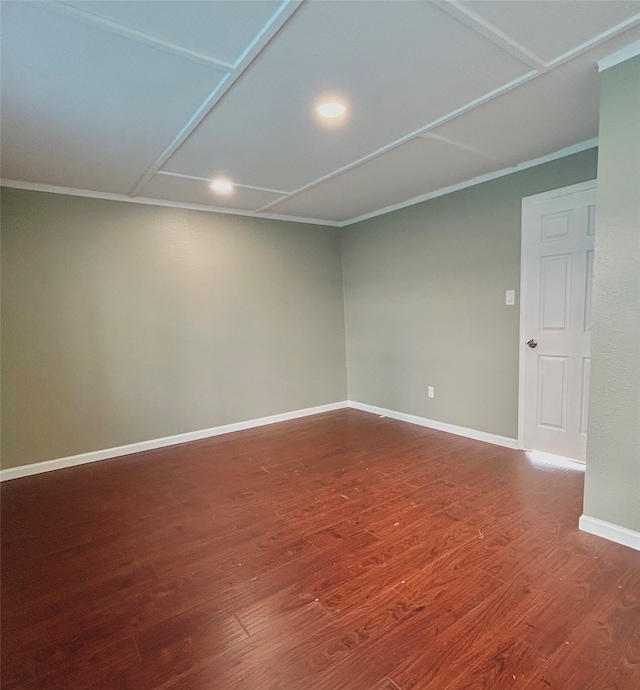 empty room featuring hardwood / wood-style floors and crown molding