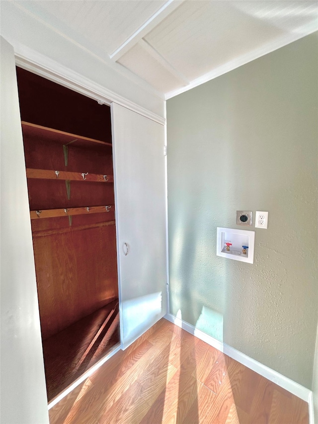 washroom featuring hookup for an electric dryer, hardwood / wood-style flooring, and washer hookup