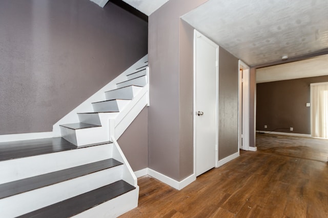 stairs with hardwood / wood-style floors