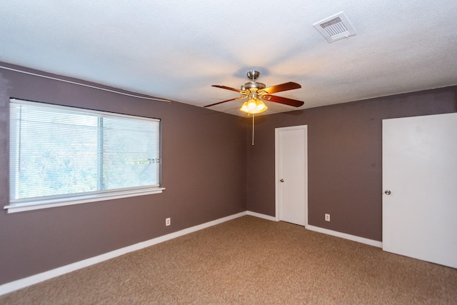 empty room featuring carpet and ceiling fan