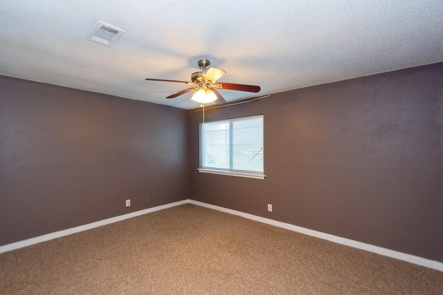 empty room with carpet, a textured ceiling, and ceiling fan