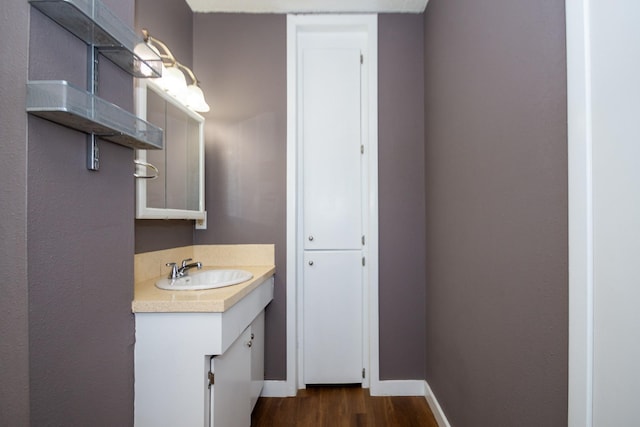 bathroom with hardwood / wood-style flooring and vanity