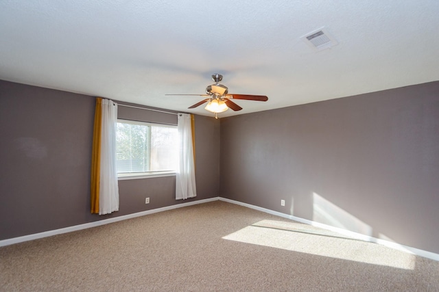 unfurnished room with carpet flooring and ceiling fan