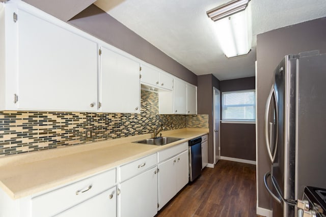 kitchen featuring backsplash, stainless steel appliances, sink, white cabinets, and dark hardwood / wood-style floors