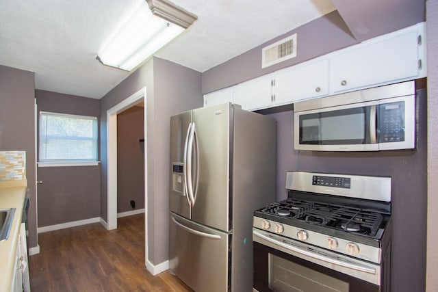 kitchen featuring white cabinetry, dark hardwood / wood-style floors, and appliances with stainless steel finishes