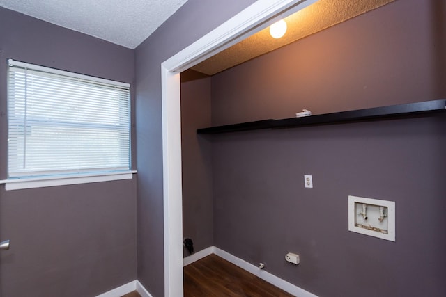 washroom with washer hookup, a textured ceiling, dark hardwood / wood-style floors, and gas dryer hookup