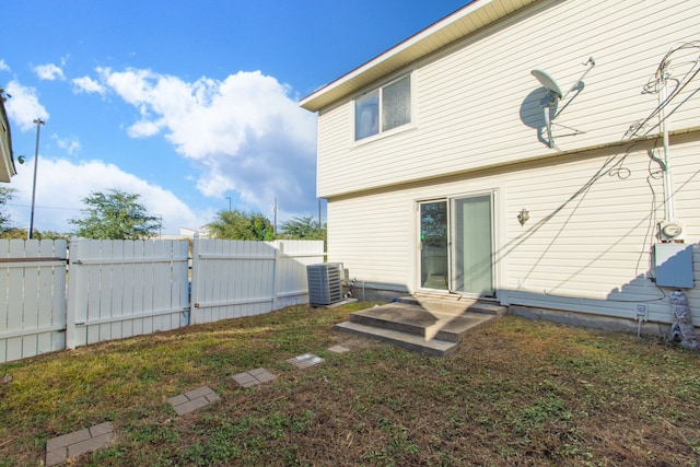 rear view of property with central AC unit