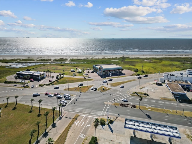 birds eye view of property with a water view and a beach view