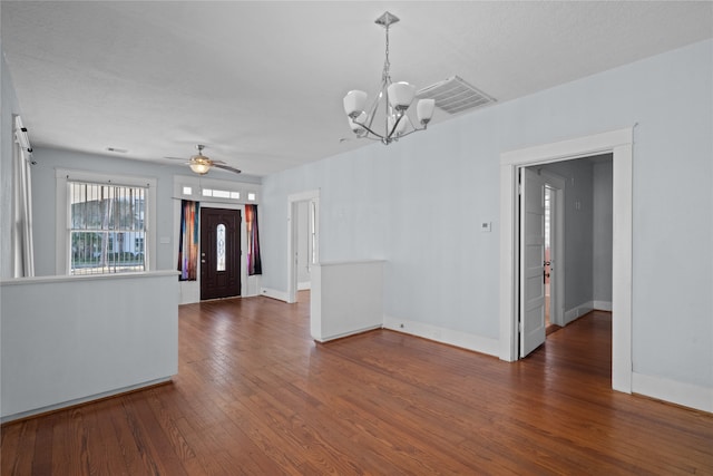 foyer with a textured ceiling, ceiling fan with notable chandelier, and dark hardwood / wood-style flooring