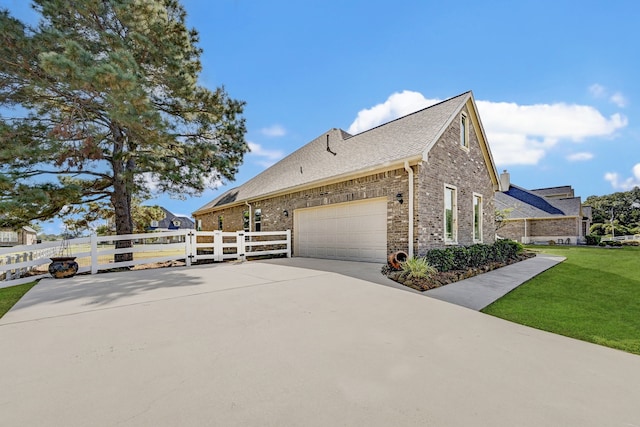 view of side of home with a yard and a garage