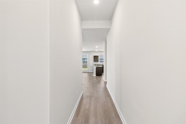 hallway with hardwood / wood-style flooring