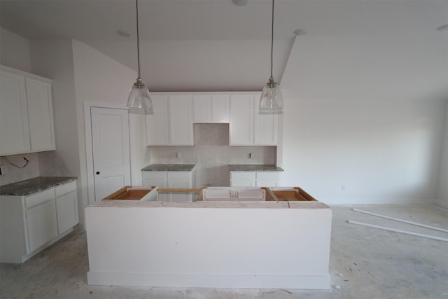 kitchen featuring hanging light fixtures, white cabinetry, and a kitchen island