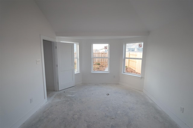 unfurnished room with lofted ceiling