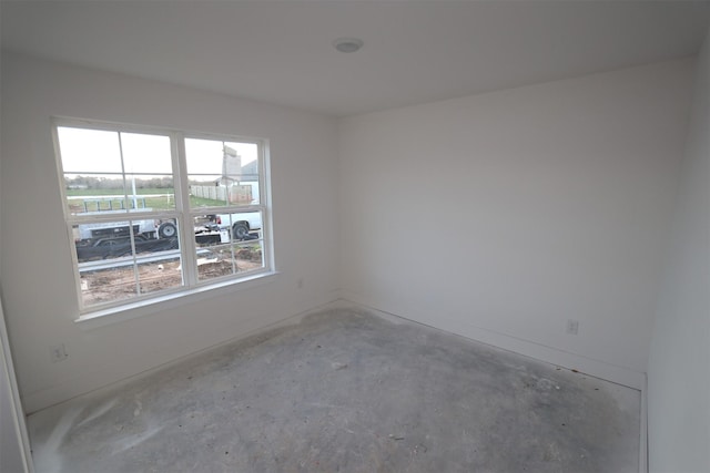 spare room featuring concrete flooring