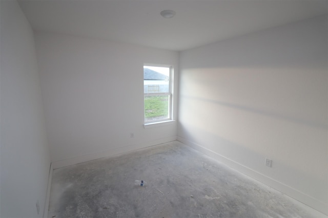 empty room with concrete flooring