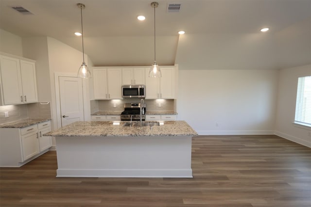 kitchen with visible vents, dark wood-style flooring, a sink, vaulted ceiling, and appliances with stainless steel finishes