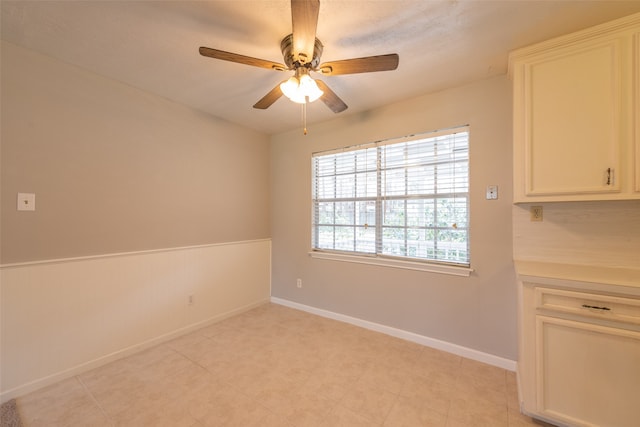 unfurnished room with ceiling fan