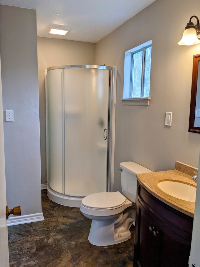 bathroom with vanity, an enclosed shower, and toilet