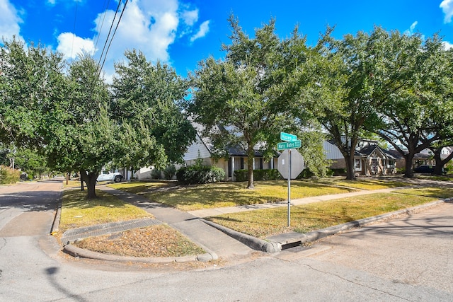 obstructed view of property featuring a front lawn