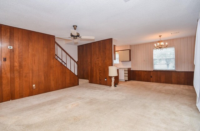 8218 Hazen St, Houston, TX 77036 - unfurnished living room with healthy amount of natural light, wood walls, stairs, a chandelier, and ceiling fan