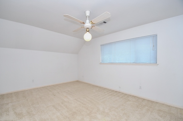 additional living space with lofted ceiling, light colored carpet, and ceiling fan