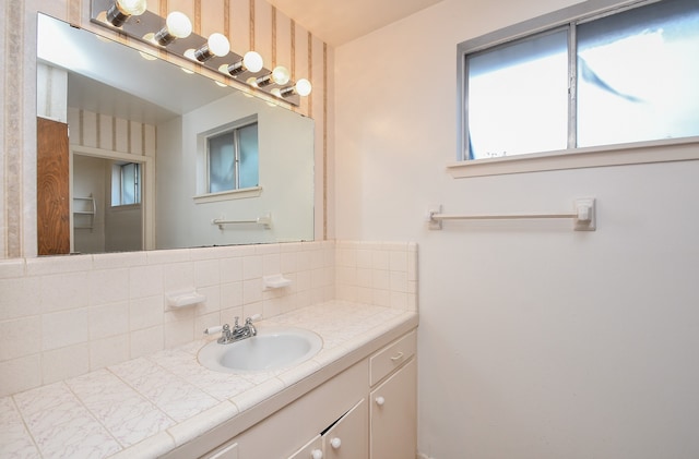 bathroom with vanity and decorative backsplash