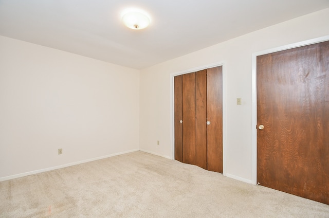 unfurnished bedroom featuring light colored carpet