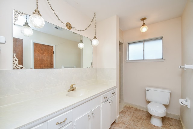 bathroom featuring vanity, toilet, and tile patterned floors