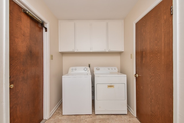 washroom featuring independent washer and dryer and cabinets