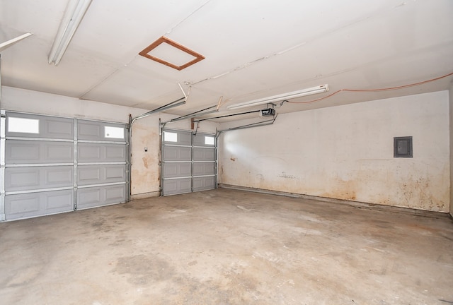 garage featuring a garage door opener and electric panel