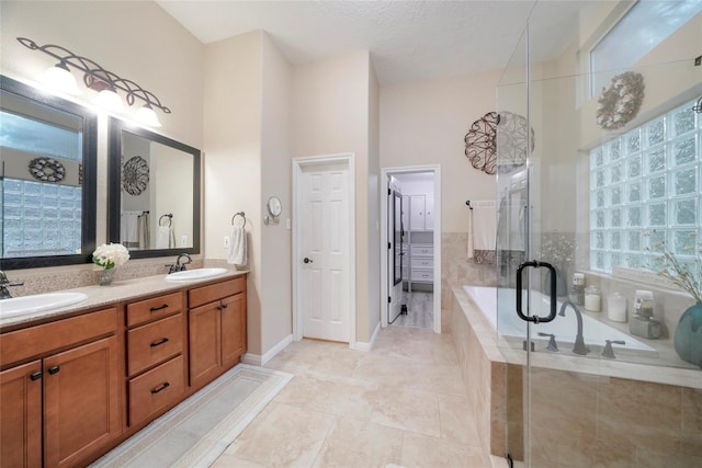 bathroom with shower with separate bathtub, a textured ceiling, a towering ceiling, vanity, and tile patterned flooring