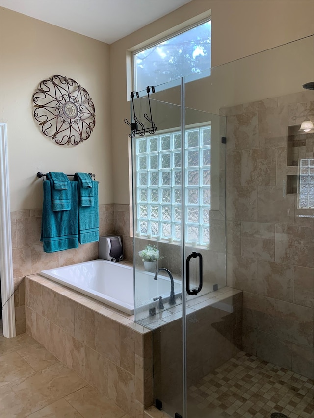 bathroom with tile patterned floors and plus walk in shower