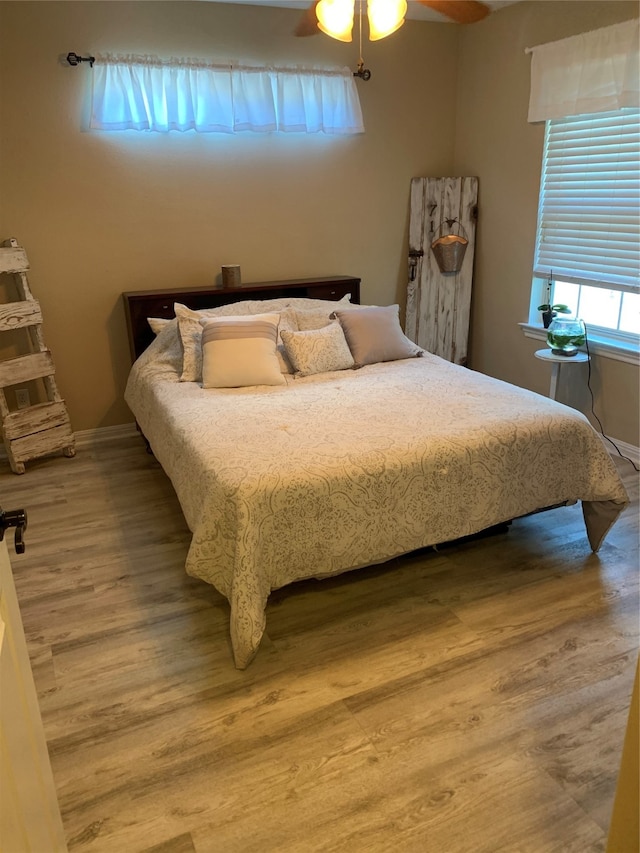 bedroom with hardwood / wood-style floors and ceiling fan