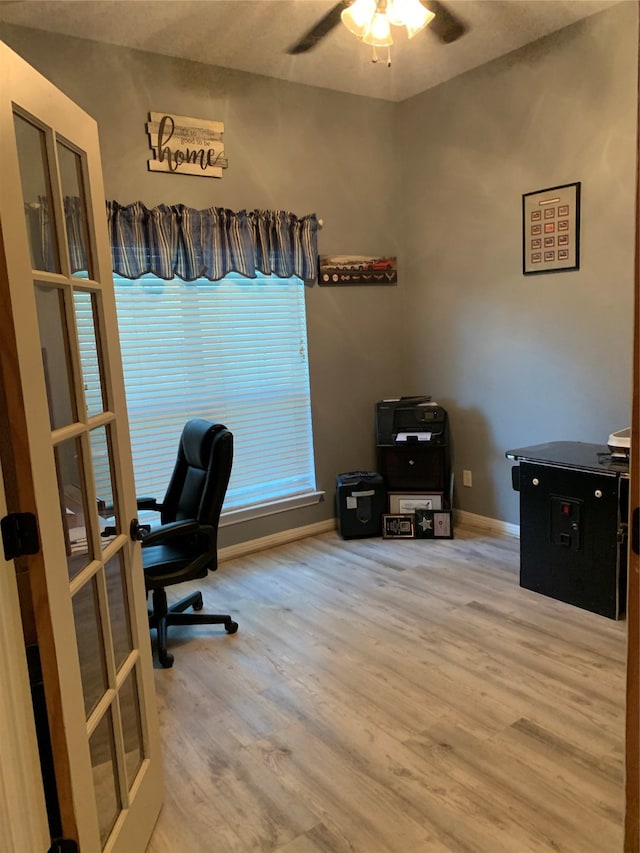 home office with wood-type flooring and ceiling fan