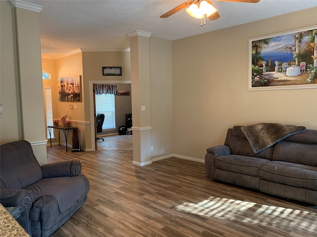 living room featuring ornamental molding, decorative columns, ceiling fan, and dark hardwood / wood-style flooring