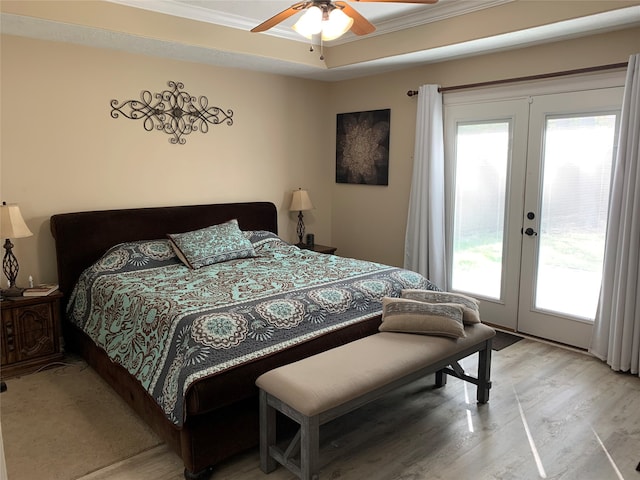 bedroom with french doors, access to outside, and multiple windows