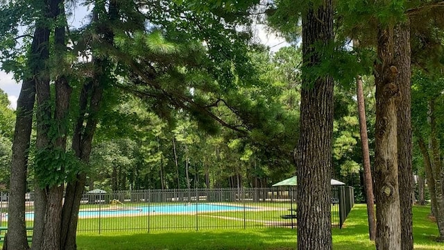 surrounding community featuring a yard and a swimming pool