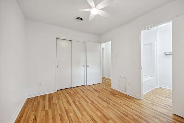 unfurnished bedroom featuring a closet, visible vents, light wood-style floors, a ceiling fan, and baseboards