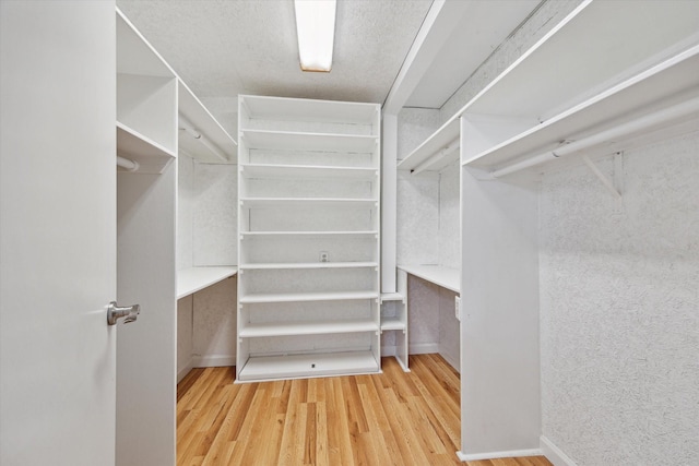 spacious closet with wood finished floors