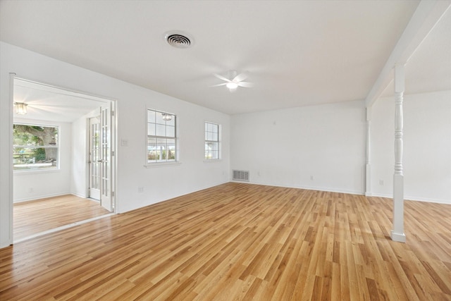 unfurnished living room featuring a ceiling fan, light wood-type flooring, and visible vents