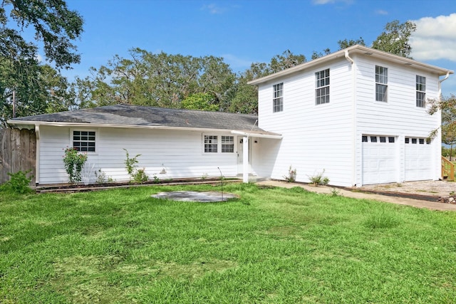 view of front of home with a garage and a front lawn