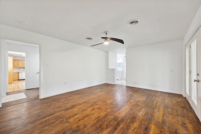 spare room with visible vents, baseboards, dark wood-style floors, ceiling fan, and a healthy amount of sunlight