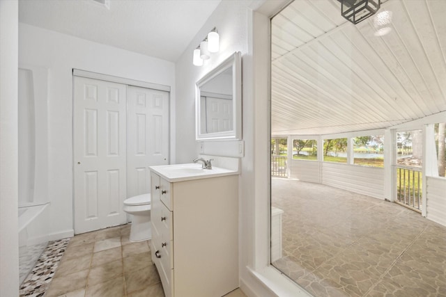 full bath with tile patterned flooring, vanity, and toilet